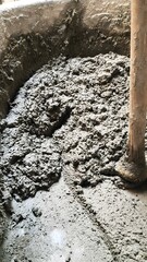 Fototapeta premium Mixing Cement Mortar in Construction Site with Shovel Close Up