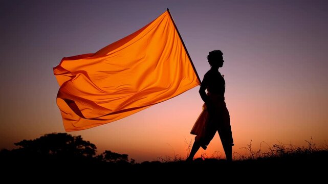 Silhouette of a person holding a large saffron flag during sunset, symbolizing cultural and religious celebration, spiritual pride, and traditional heritage
