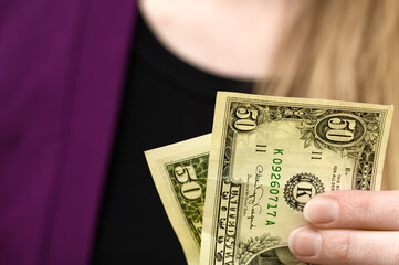 paying for purchases, payment, woman holding a 50 dollar bill in her hand
