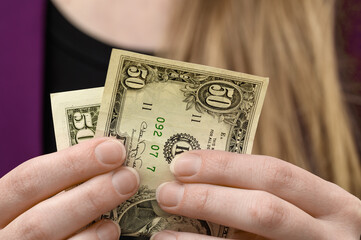 US currency, dollars held in a hand close up