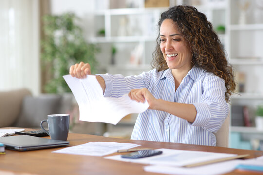 Happy adult freelance worker breaking ended contract at home