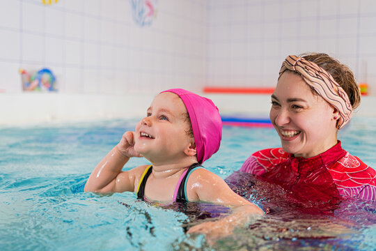 Child learning swim lesson with instructor.
