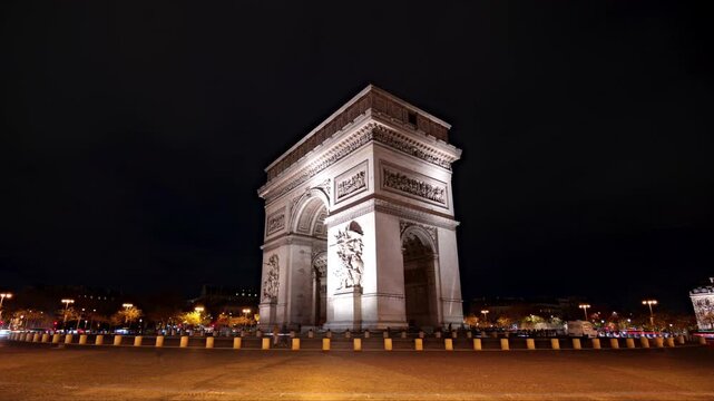 Arc De Triomphe monument hyperlapse in Paris France with heavy traffic during night with car trails