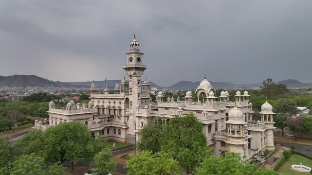 Mayo college heritage building surrounded by garden and aravalli hills under overcast sky, drone shot
