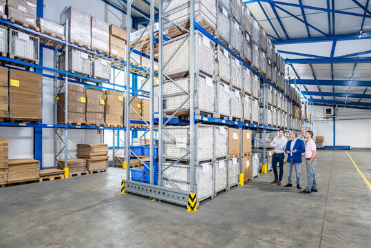 Logistics professionals meeting in modern warehouse storage facility