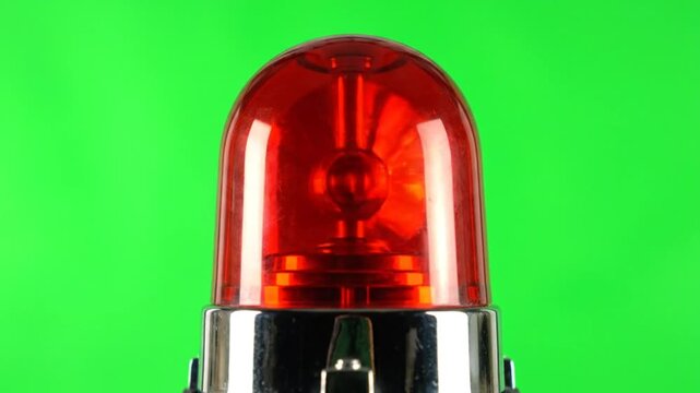 Red police or emergency siren flashing and rotating on a green screen for special effects or alerts