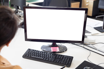 Cropped image of businesswoman with blank computer monitor at desk in office, copy space