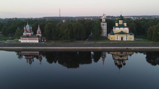 Aerial panoramic view of the historic Uglich Kremlin from above, traveling along the Volga River. Drone shot.