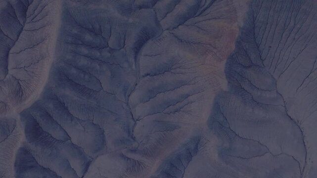 Aerial view of a network of canyons and gullies creates a mesmerizing landscape with contrasting tones and textures, Hanksville, Utah, United States.
