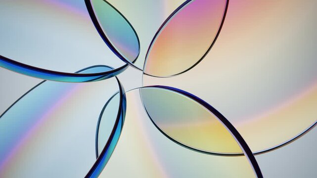 Close up of precision iridescent discs glass plates on light background. Endless loop.