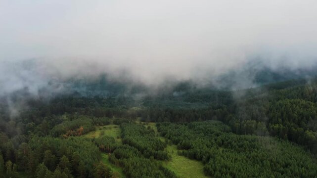 Southern Urals in summer: Southern Kraka ridge, aerial view. Evening fog in the mountains.
