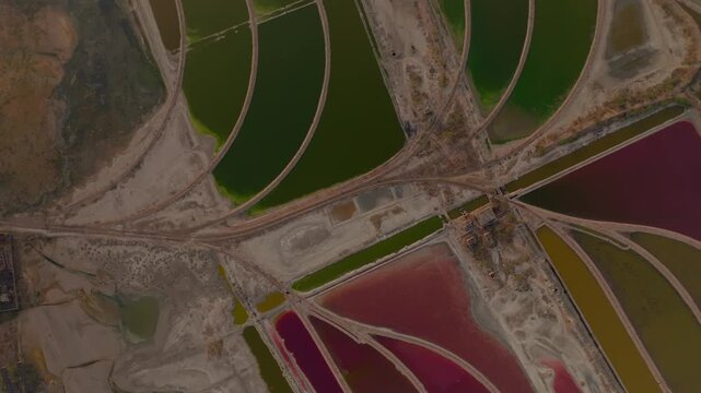 Aerial view of vibrant salt ponds displaying a vivid array of colors creating a stunning mosaic pattern, Sambhar, Rajasthan, India.