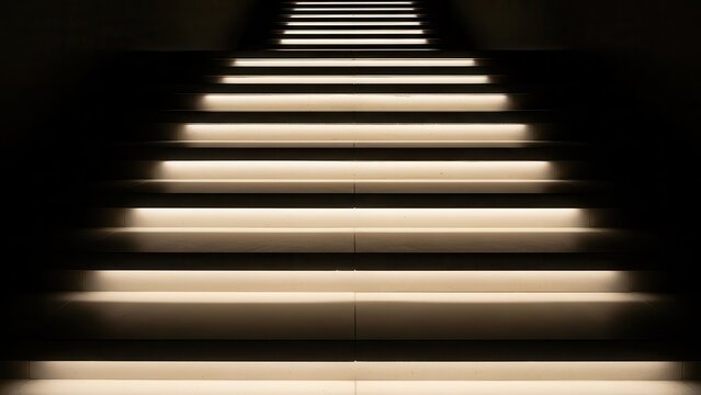 A minimalist and modern architectural staircase crafted from smooth, light-colored concrete steps, dramatically illuminated from beneath with warm, glowing light that recedes into profound darkness,
