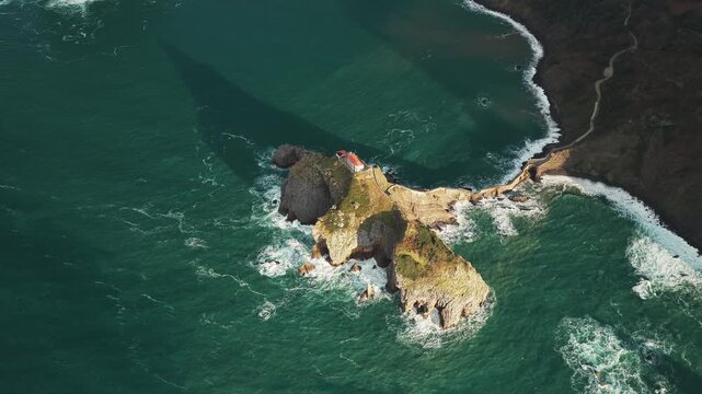 Aerial view of Gaztelugatxe Island, a rocky islet topped by a hermitage, connected to the mainland by a narrow, winding bridge, San Juan de Gaztelugatxe, Euskadi, Spain.