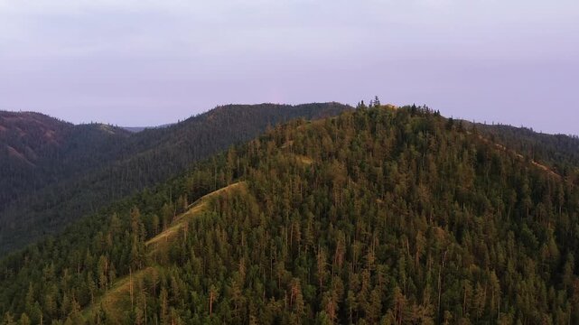 Southern Urals in summer: Southern Kraka ridge, aerial view. Evening fog in the mountains.