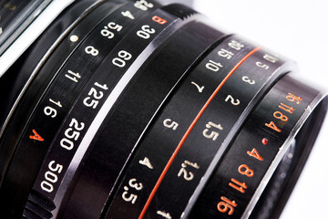 Distance, shutter speed and aperture scale on lens of old camera