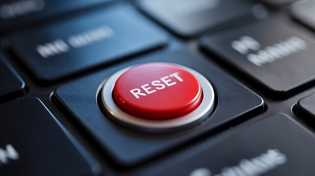 Red reset button on a black keyboard with various other keys visible