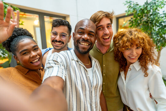 Diverse business people taking selfie during office break