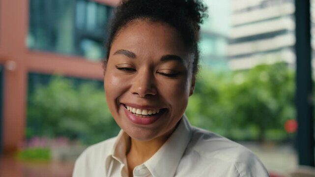 Portrait surprised African American business woman looking at camera with excited expression happy businesswoman female girl open mouth amazing emotion work job success achievement in city downtown