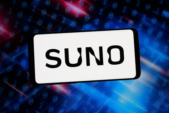 Stuttgart, Germany - 02-06-2026: In this photo illustration, the logo of US AI music generation company Suno Inc. is displayed on a smartphone in front of abstract background on computer screen.