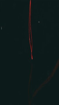 Red thread descends into darkness, reflecting subtly below