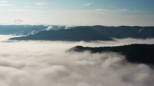 Southern Urals in summer: Southern Kraka ridge, aerial view. Morning fog in the mountains.