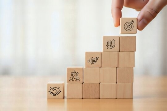 Business Strategy Planning. Hand stacking wooden cubes into step structure with partnership growth and goal symbols, symbolizing scalable development strategic alignment and performance improvement.
