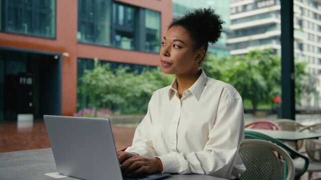 Pensive thinking African American business woman working laptop think idea solution female girl businesswoman work computer in city cafe entrepreneur pondering solving internet question author lady