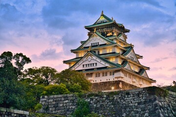 Osaka Castle Main Tower Illuminated at Blue Hour from Royal Boat Pier with Pink Sunset Sky