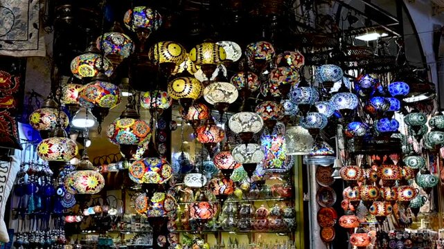 Istanbul, turkey, august 13, 2025. Colorful turkish mosaic lamps and lanterns illuminating a traditional market stall. Beautiful handmade glass chandeliers creating a vibrant and magical atmosphere. S