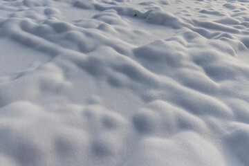 details a lot of small snowdrifts , soft and fluffy freshly fallen snow in the winter season in...
