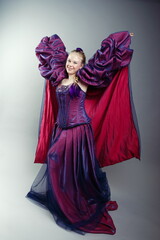 Joyful Girl in Dramatic Purple Fantasy Gown