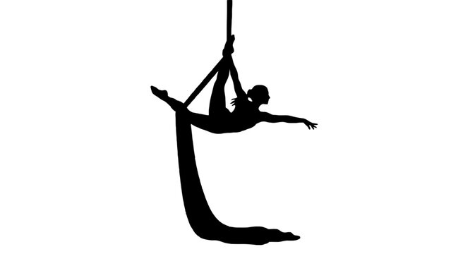 Silhouette woman performing aerial yoga with colorful silk fabric in mid-air