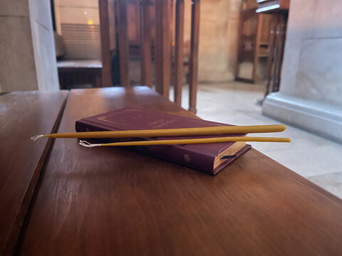 bible with candles in orthodox chirch