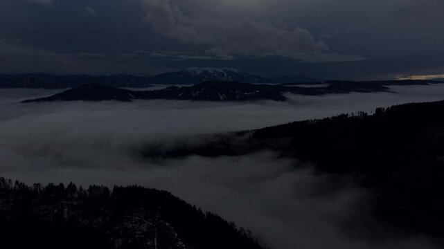 Heavy cloud ceiling over rolling mountain hills