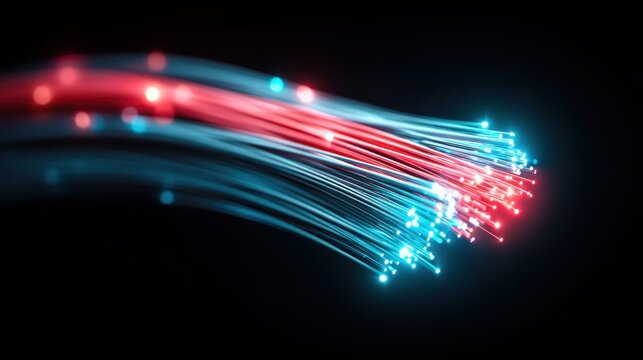 Close-up of glowing fiber optic strands in red and blue light against a dark background