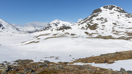 Snow-covered landscape at Leirvassbu in Leirdalen during clear weather in Jotunheimen National Park in Norway