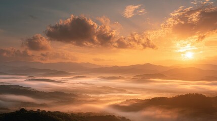 Fototapeta premium Serene Sunrise Over Misty Mountains with Golden Clouds and Horizon