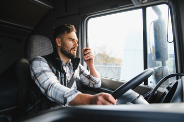 Trucker communicating using radio while driving big rig