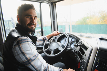 Naklejka premium Truck driver sitting in cabin, transporting goods by road