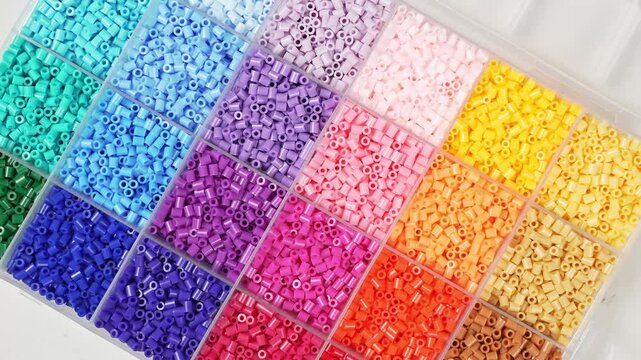 colorful plastic polymer granules on blue background