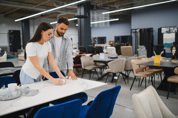 Obraz premium Couple shopping in furniture store, choosing home decor