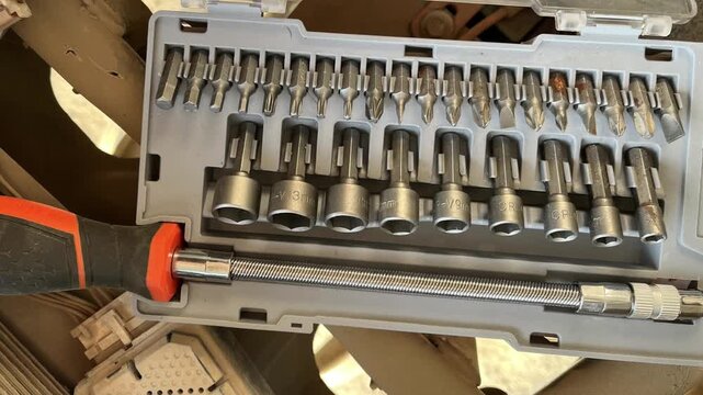 Professional screwdriver bit and socket set in a portable grey plastic case