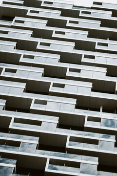 Residential architecture facade with modern balcony pattern in urban Frankfurt Germany showing repetition of stacked terraces and highrise grids