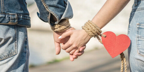 Hands of a couple exchanging red hearts along with ideas about love and care