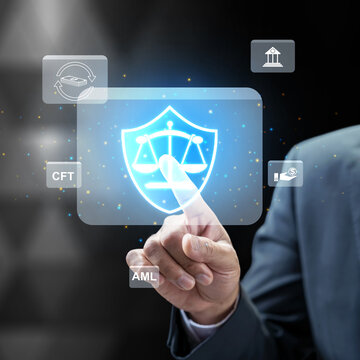 Businessman interacting with a futuristic digital interface for AML and CFT compliance, featuring a legal shield and scales representing financial security and regulatory law