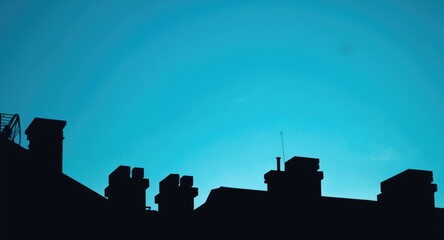 Fototapeta premium Dark silhouettes of rooftops on a bright clean background