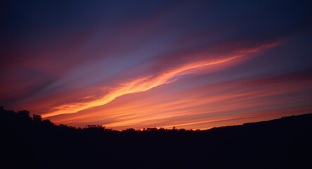 Fototapeta premium luminous sunset streak glowing over a dusky nighttime sky