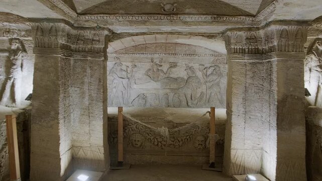 Handheld footage of Principal tomb chamber at Catacombs of Kom El Shoqafa, historical archaeological site located in Alexandria, Egypt, considered one of the Seven Wonders of the Middle Ages