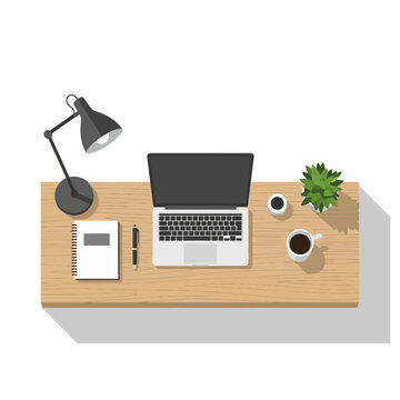 Top View of Modern Workspace with Laptop, Coffee, Plant, and Lamp on a Wooden Desk, Isolated White Background